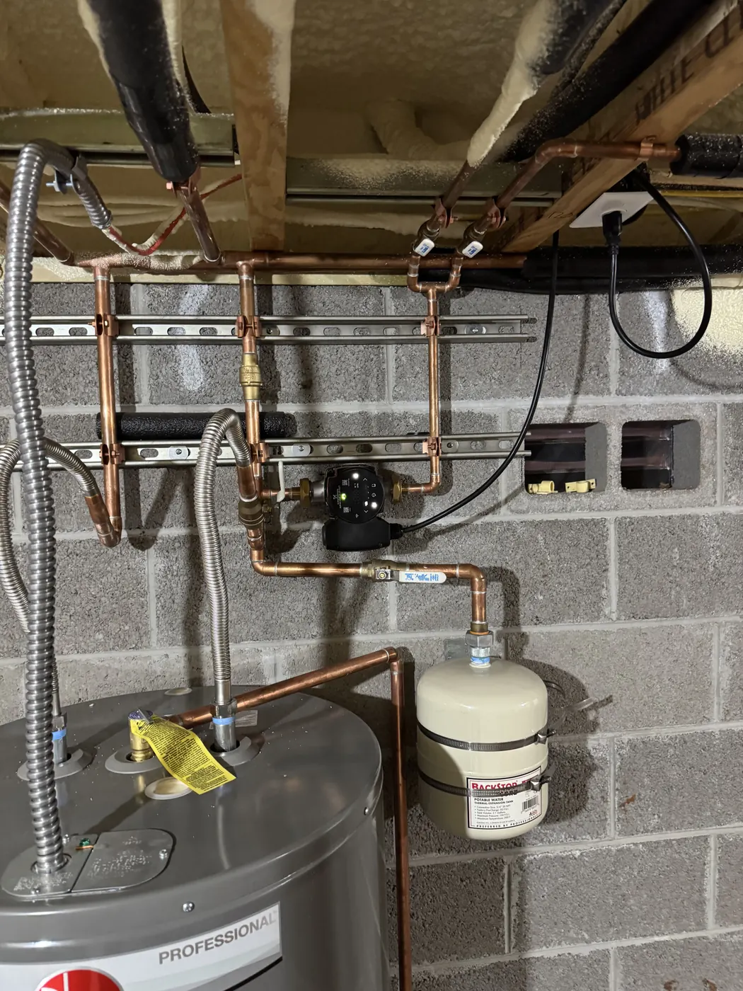 Electric tank water heater with new copper lines and a thermal expansion tank